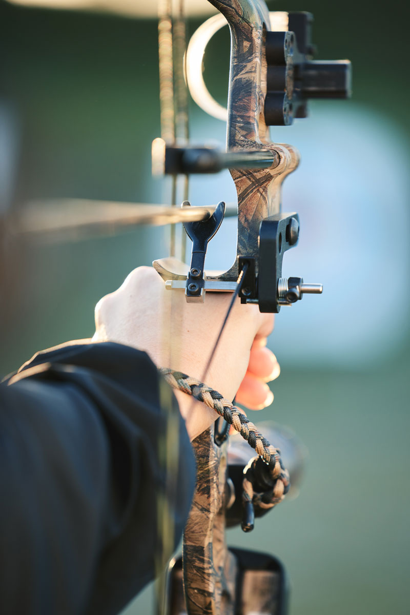 Hunter drawing back the string of a bow.