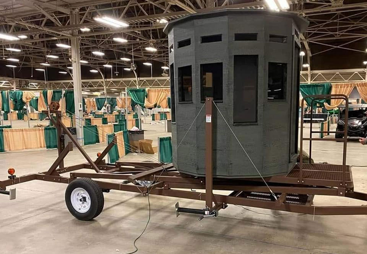 Mobile hunting blind mounted on a trailer.
